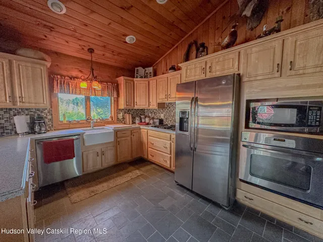 a kitchen with stainless steel appliances cabinets a sink and a window