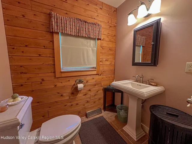 a bathroom with a sink a toilet and mirror