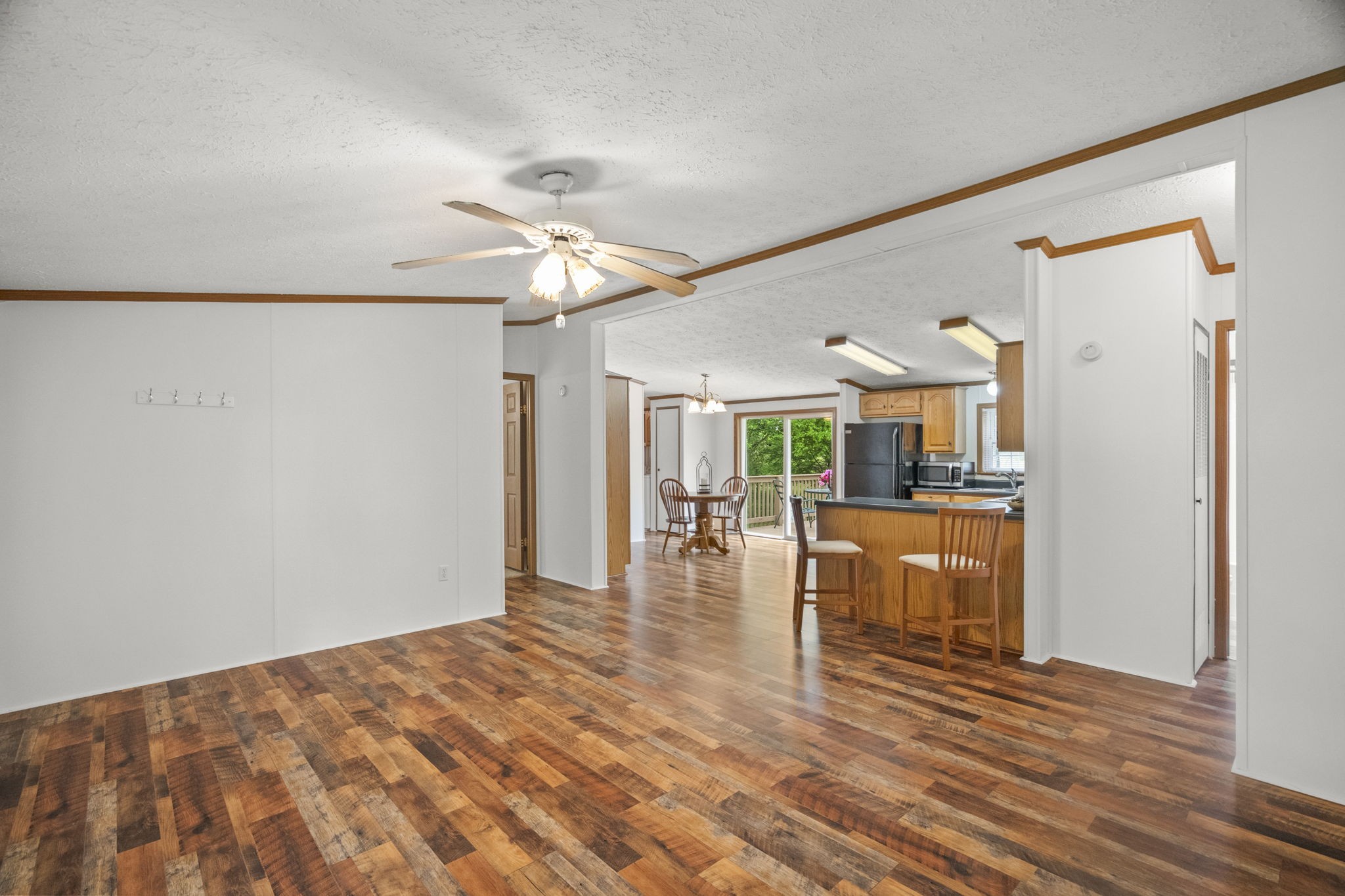 4012 Armstrong Road Springfield, TN 37172 - Photo 16 of 39 a view of a livingroom with wooden floor and a ceiling fan