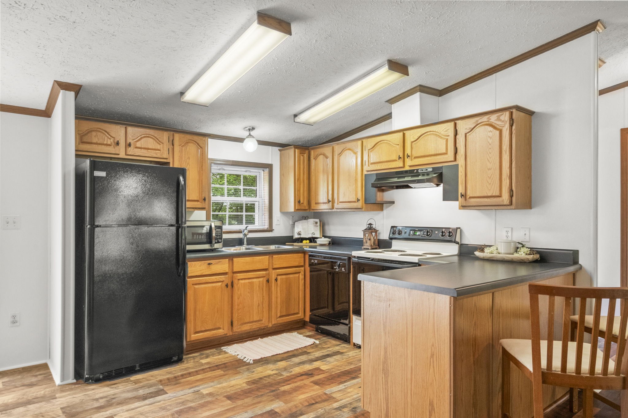 4012 Armstrong Road Springfield, TN 37172 - Photo 18 of 39 a kitchen with stainless steel appliances granite countertop a refrigerator a sink dishwasher a stove with wooden cabinets and floor