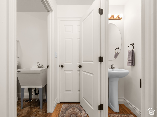 1288 North Horizon View Loop Elk Ridge, UT 84651 - Photo 19 of 38 Pedestal sink with chrome faucet, oval mirror, and wood-finish flooring