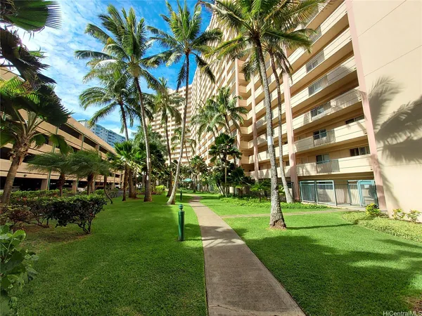 a view of a building with a yard