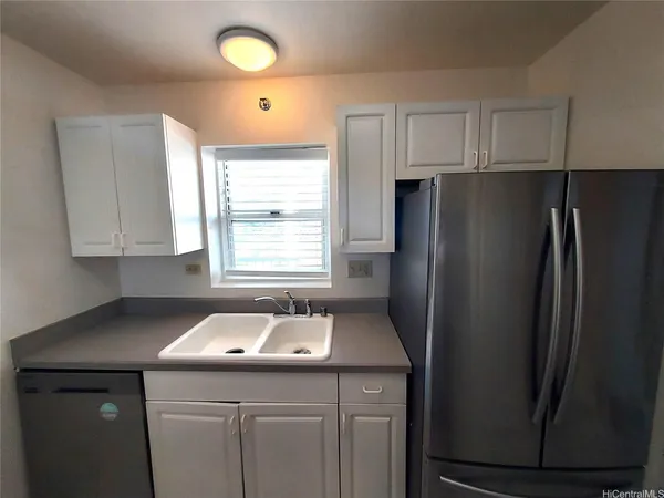 a kitchen with refrigerator and window