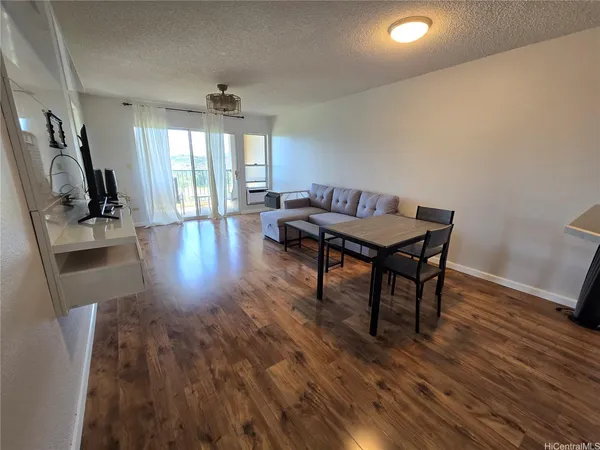 a view of a workspace with furniture window and wooden floor