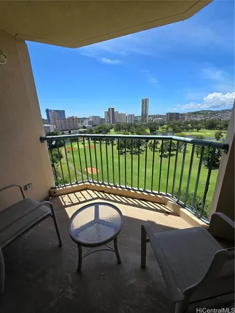 a view of a balcony with two chairs and a table