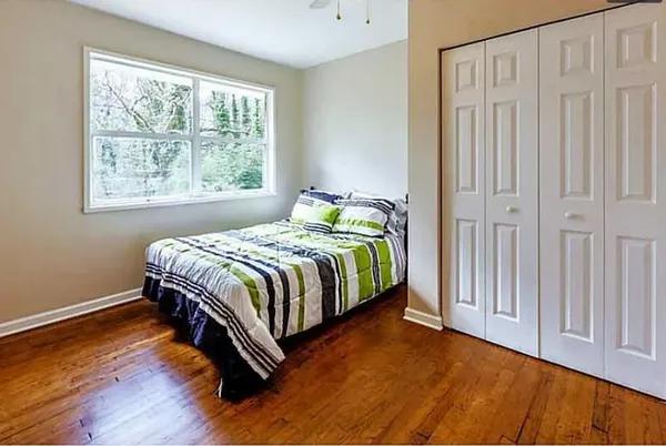 a bedroom with a bed and a window
