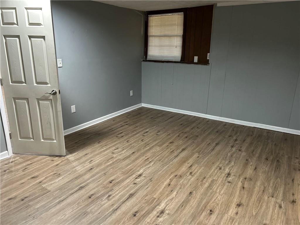 3637 Windmill Road Ellenwood, GA 30294 - Photo 5 of 6 an empty room with wooden floor and windows