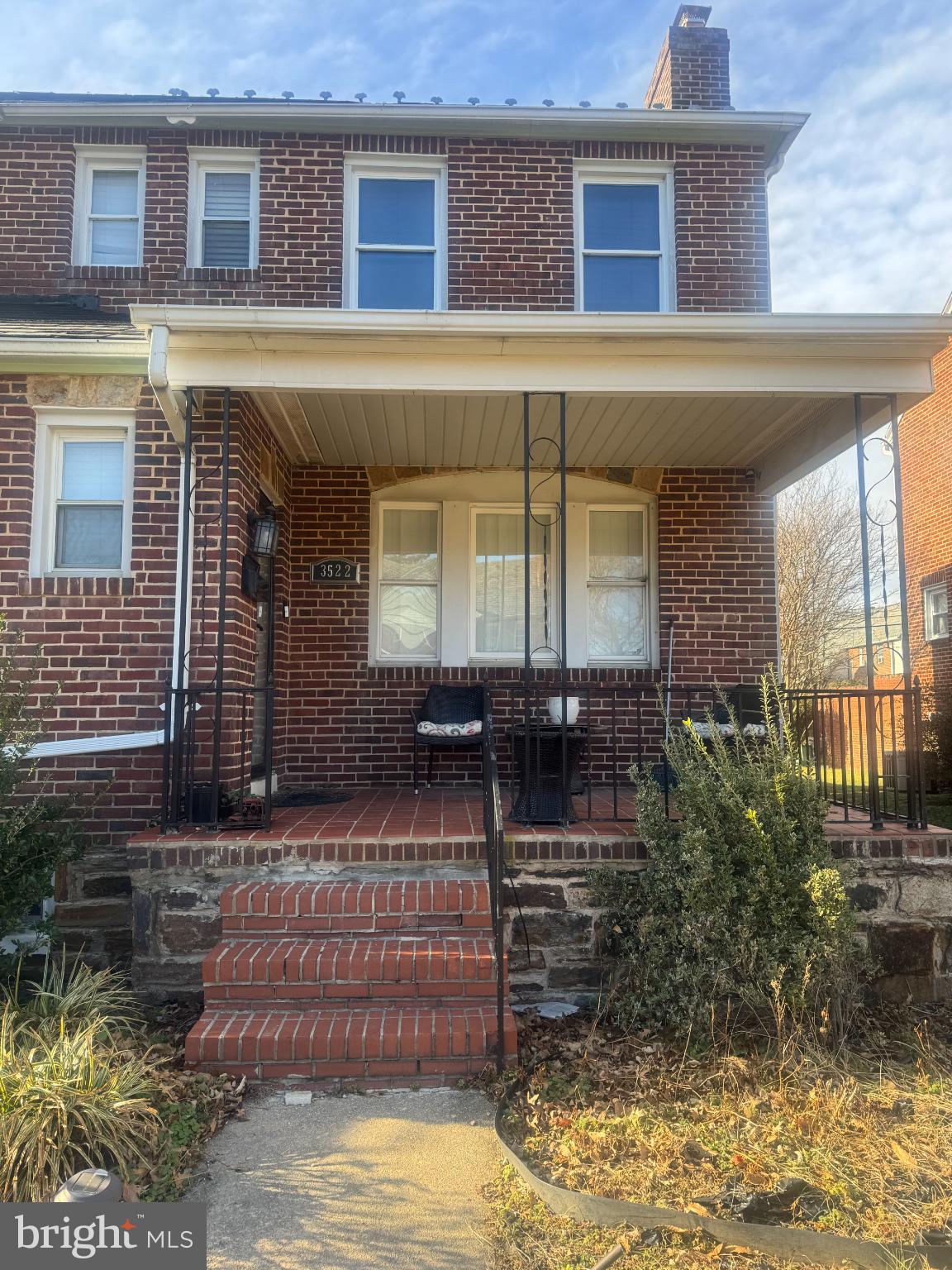 Charming brick facade with inviting porch.