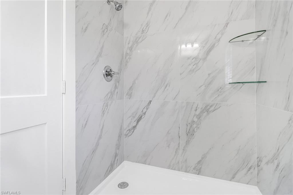 981 11th Street Southwest Naples, FL 34117 - Photo 16 of 24 Bathroom featuring tiled shower