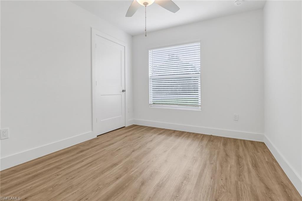 981 11th Street Southwest Naples, FL 34117 - Photo 17 of 24 Empty room with light hardwood / wood-style flooring and ceiling fan