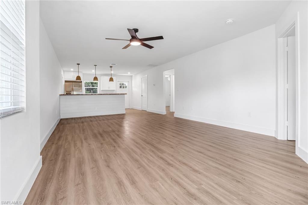 981 11th Street Southwest Naples, FL 34117 - Photo 18 of 24 Unfurnished living room featuring light wood-type flooring and ceiling fan