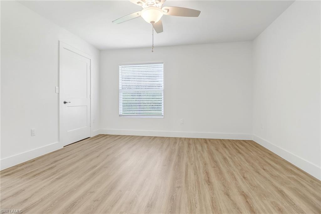 981 11th Street Southwest Naples, FL 34117 - Photo 20 of 24 Unfurnished room with light wood-type flooring and ceiling fan
