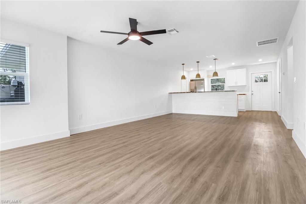 981 11th Street Southwest Naples, FL 34117 - Photo 21 of 24 Unfurnished living room with ceiling fan and light hardwood / wood-style floors
