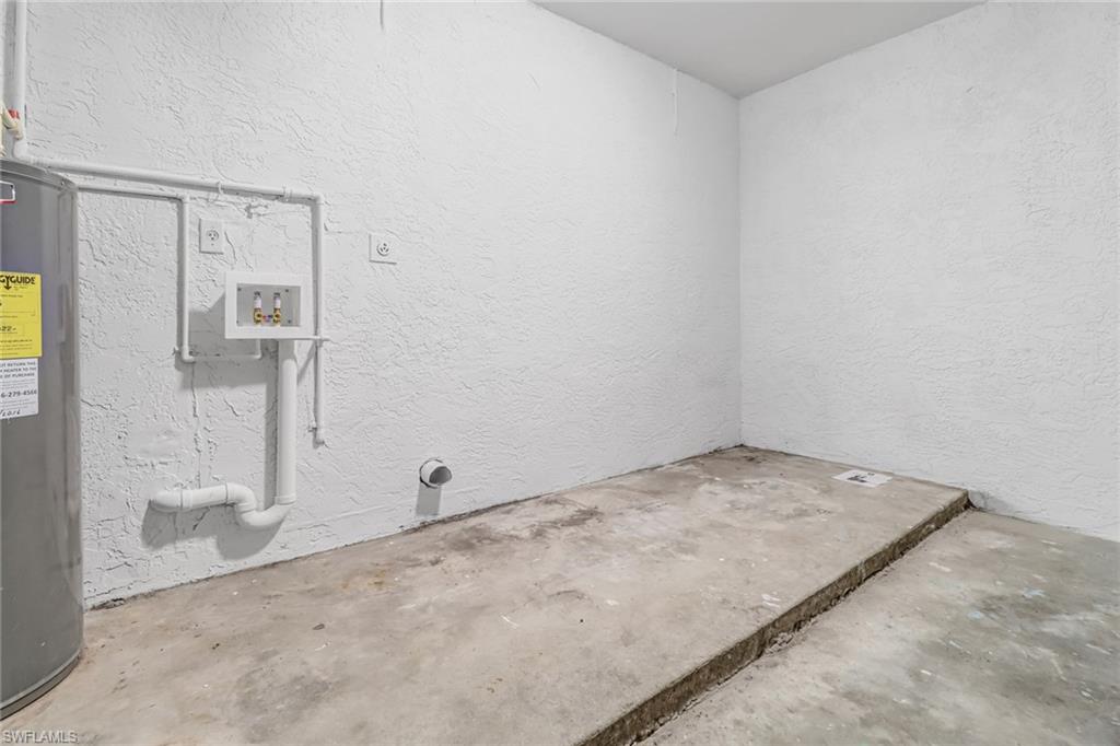 981 11th Street Southwest Naples, FL 34117 - Photo 23 of 24 Clothes washing area featuring hookup for a washing machine, water heater, and hookup for an electric dryer