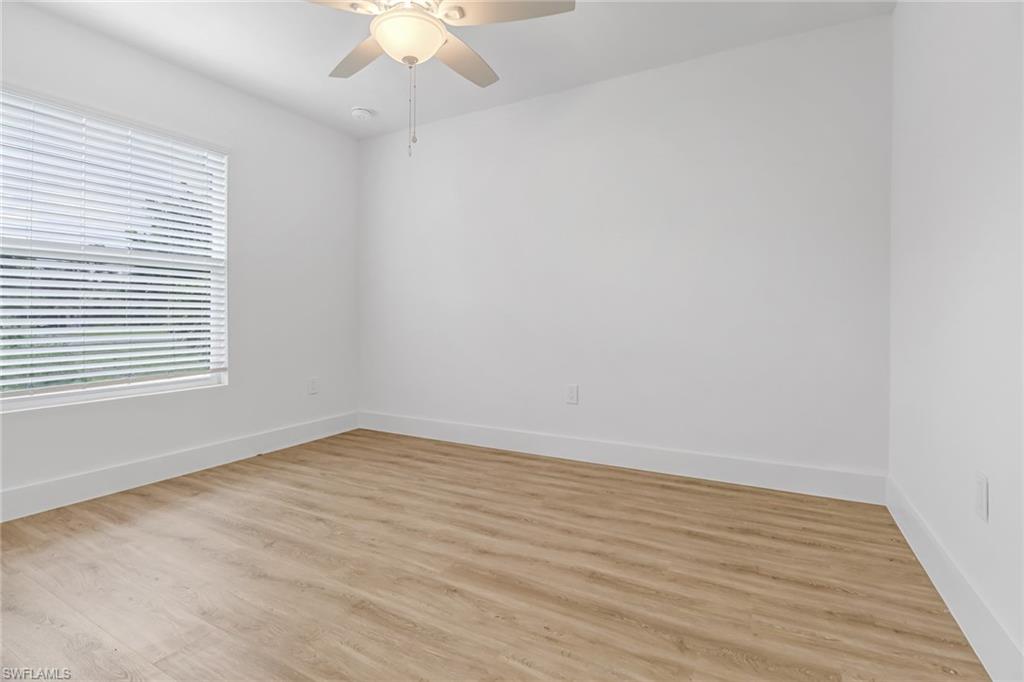 981 11th Street Southwest Naples, FL 34117 - Photo 9 of 24 Unfurnished room featuring light wood-type flooring and ceiling fan