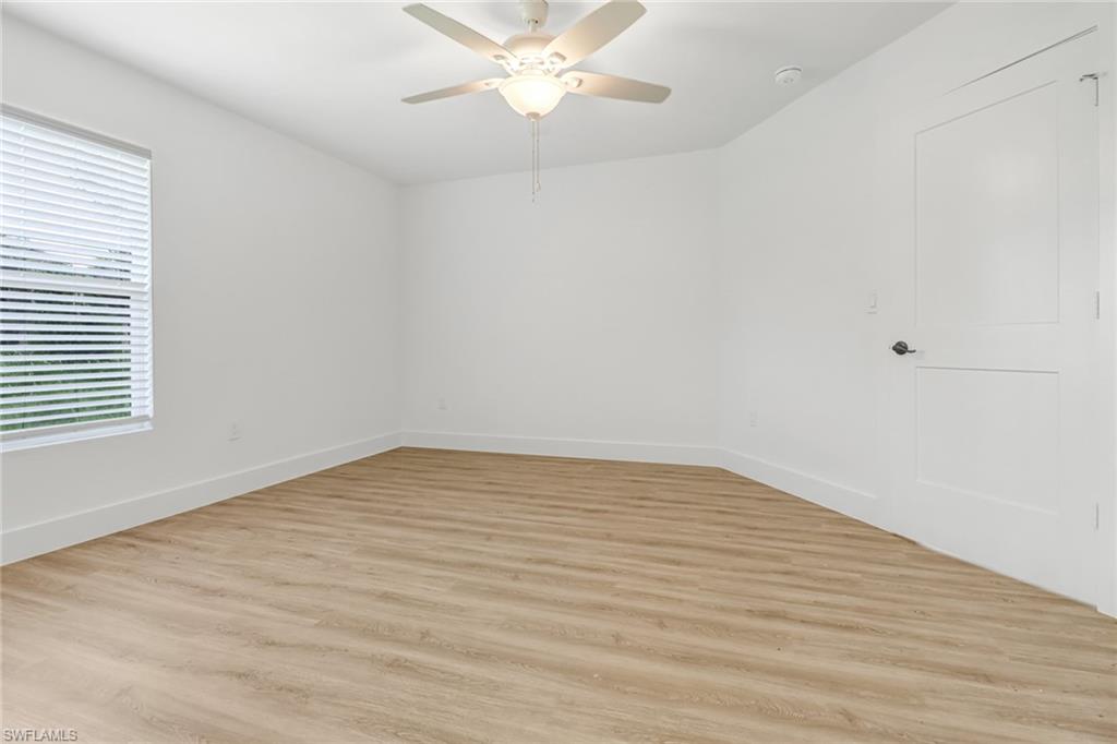 981 11th Street Southwest Naples, FL 34117 - Photo 10 of 24 Empty room with ceiling fan and light hardwood / wood-style flooring