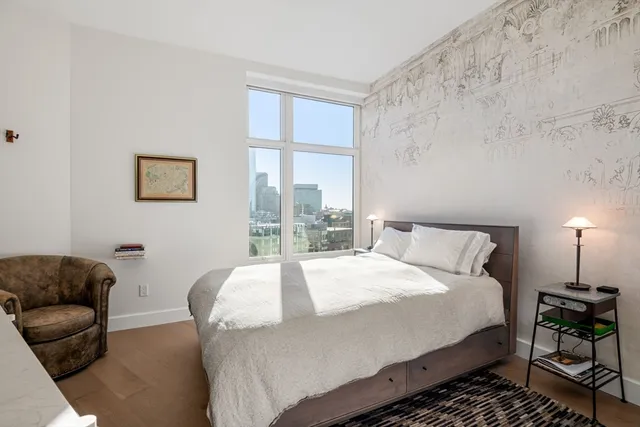 a bedroom with a bed couch and a window