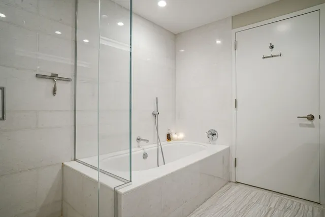 a bathroom with a bathtub and a shower