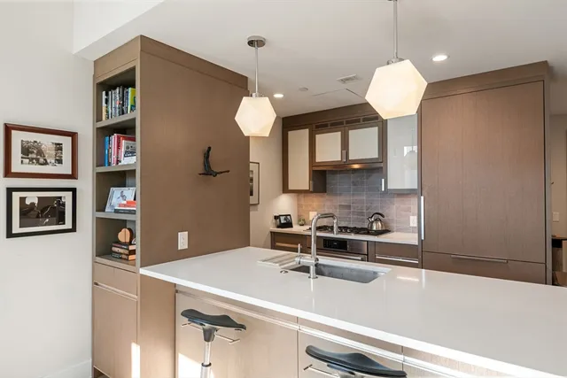 a kitchen with a sink stainless steel appliances and cabinets