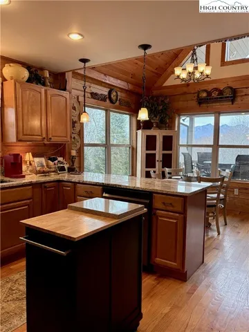 a kitchen with stainless steel appliances granite countertop a sink and a stove