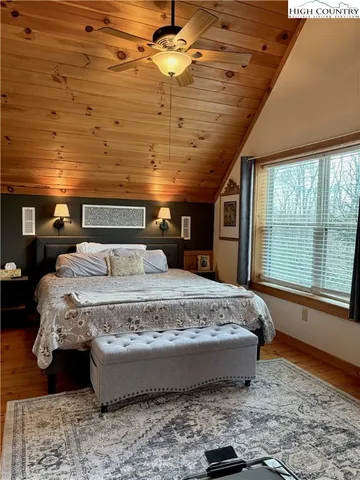 a large bed sitting in a room next to a window