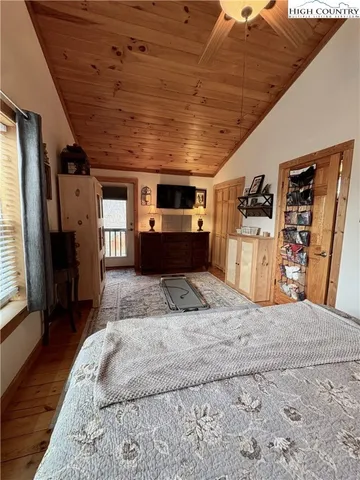 a spacious bedroom with a bed and a kitchen