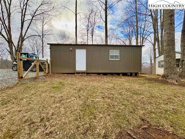 a view of backyard space with large trees