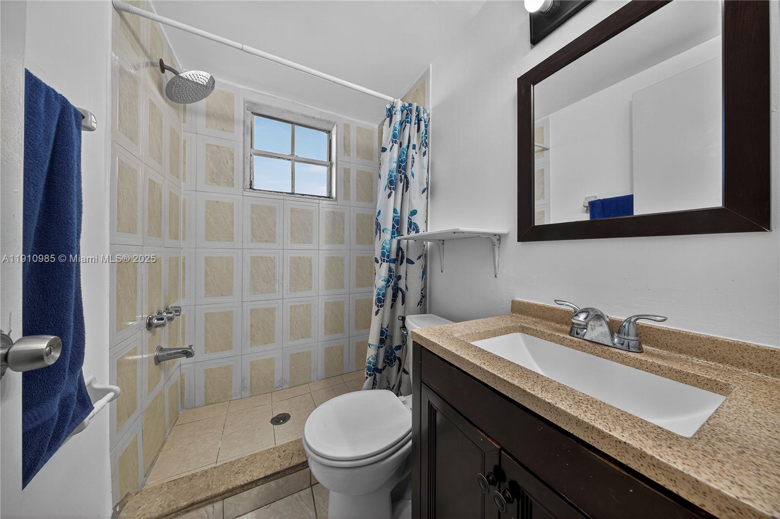 12045 Southwest 18th Street, Unit 142 Miami, FL 33175 - Photo 13 of 18 a bathroom with a granite countertop sink toilet and shower