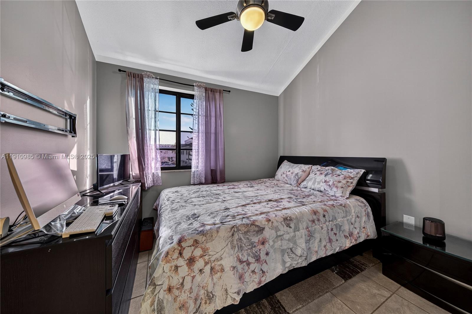 12045 Southwest 18th Street, Unit 142 Miami, FL 33175 - Photo 16 of 18 a bedroom with a bed and a chandelier