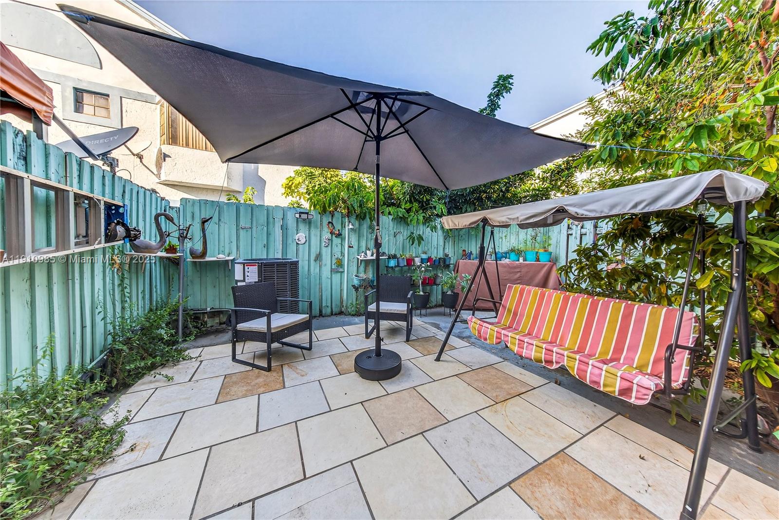 12045 Southwest 18th Street, Unit 142 Miami, FL 33175 - Photo 18 of 18 a view of chairs and tables in the patio