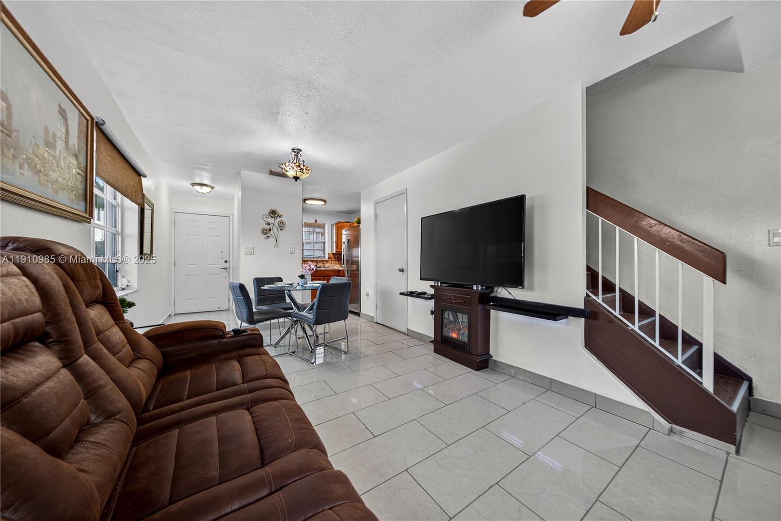 12045 Southwest 18th Street, Unit 142 Miami, FL 33175 - Photo 3 of 18 a living room with furniture and a flat screen tv