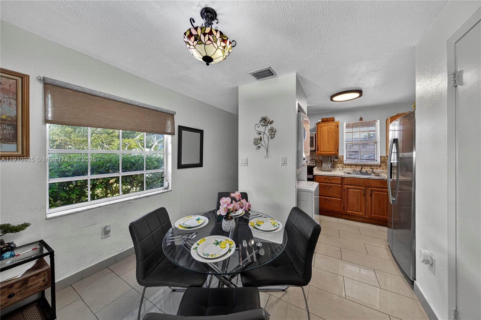 12045 Southwest 18th Street, Unit 142 Miami, FL 33175 - Photo 4 of 18 a view of a dining room with furniture a rug and wooden floor