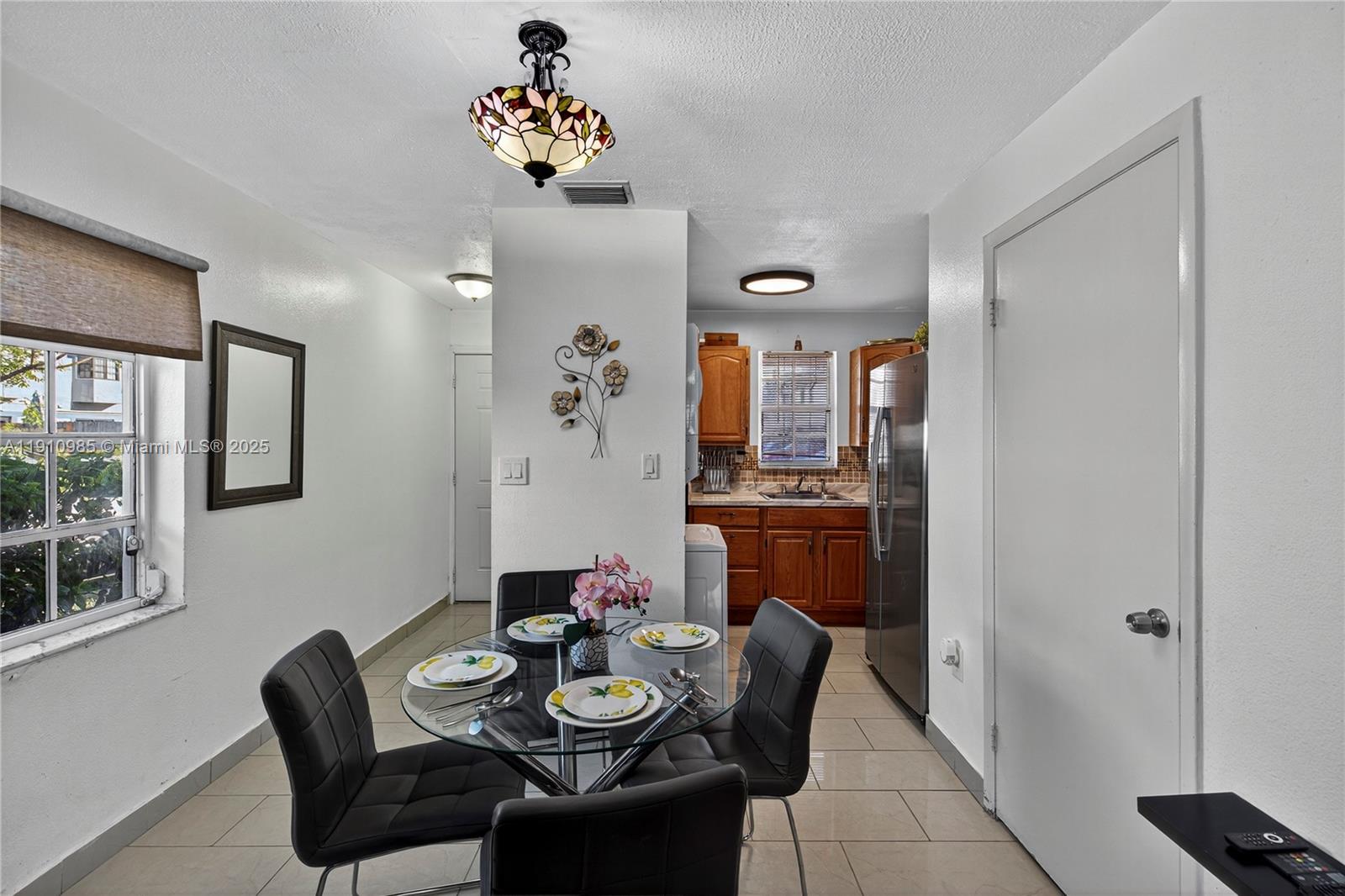 12045 Southwest 18th Street, Unit 142 Miami, FL 33175 - Photo 5 of 18 a dining room with furniture a rug and wooden floor