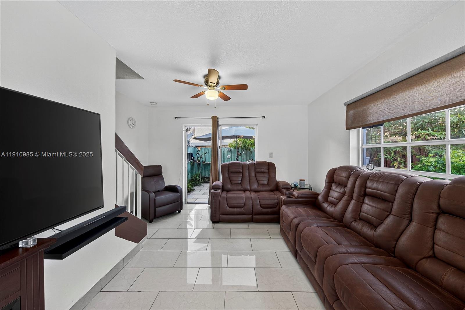 12045 Southwest 18th Street, Unit 142 Miami, FL 33175 - Photo 7 of 18 a living room with furniture a ceiling fan and a window