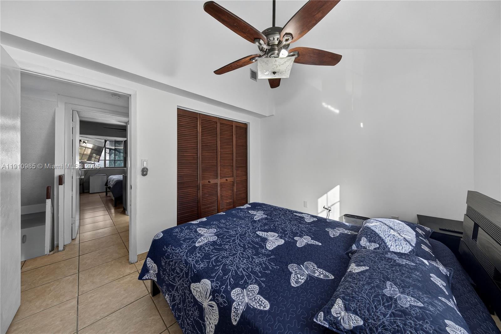 12045 Southwest 18th Street, Unit 142 Miami, FL 33175 - Photo 9 of 18 a bedroom with a bed and a chandelier