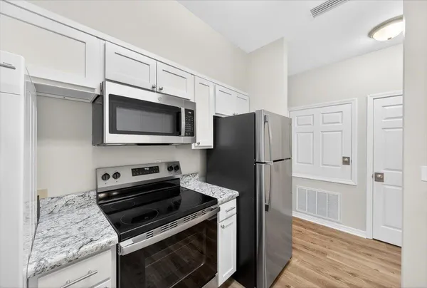 a kitchen with a stove microwave and refrigerator