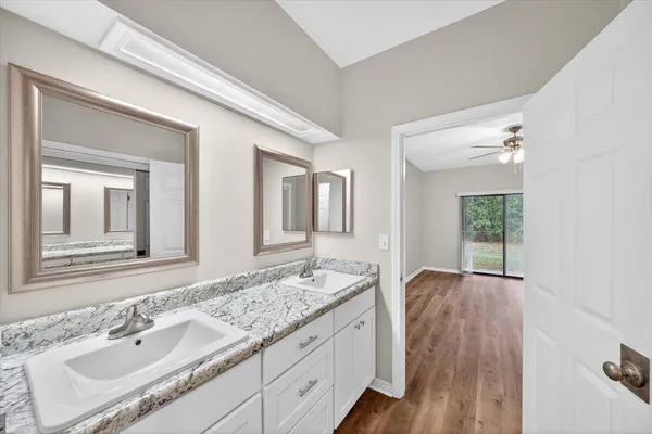 a bathroom with a granite countertop sink mirror and vanity