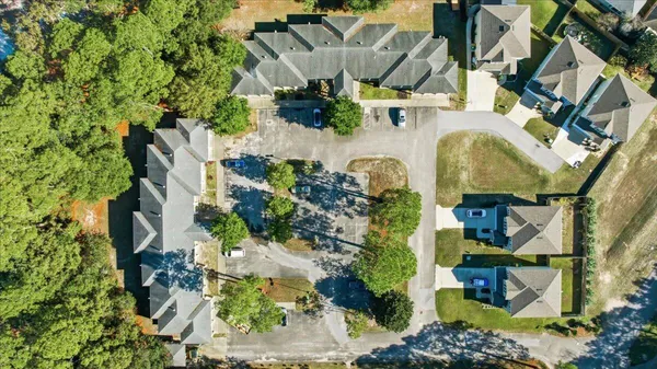 an aerial view of residential houses with outdoor space