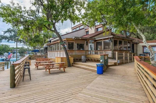 a view of a house with pool and sitting area