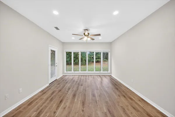 wooden floor in an empty room with a window