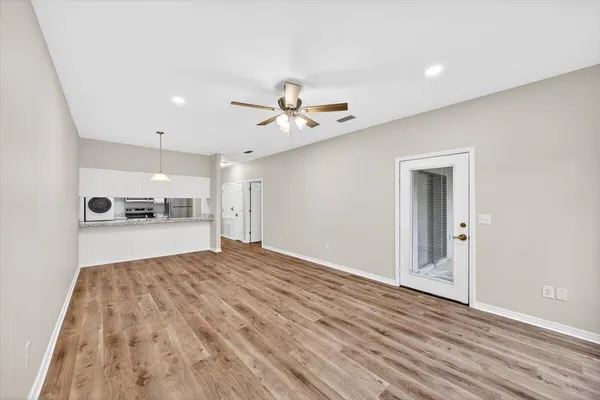 a view of a kitchen with a sink and a chandelier fan