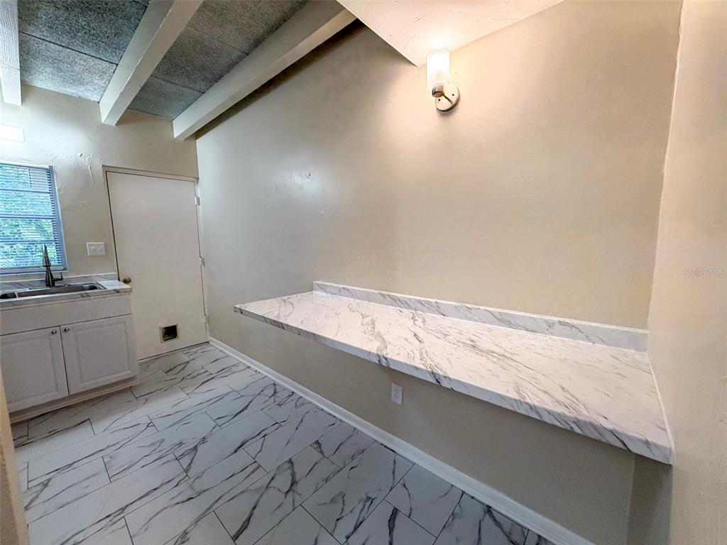 219 Northwest 3rd Avenue, Unit B Gainesville, FL 32601 - Photo 7 of 20 a view of a kitchen with wooden floor
