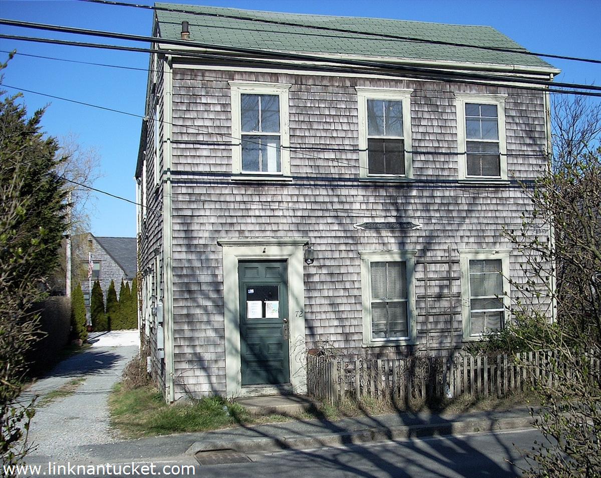 facade with small fenced front yard