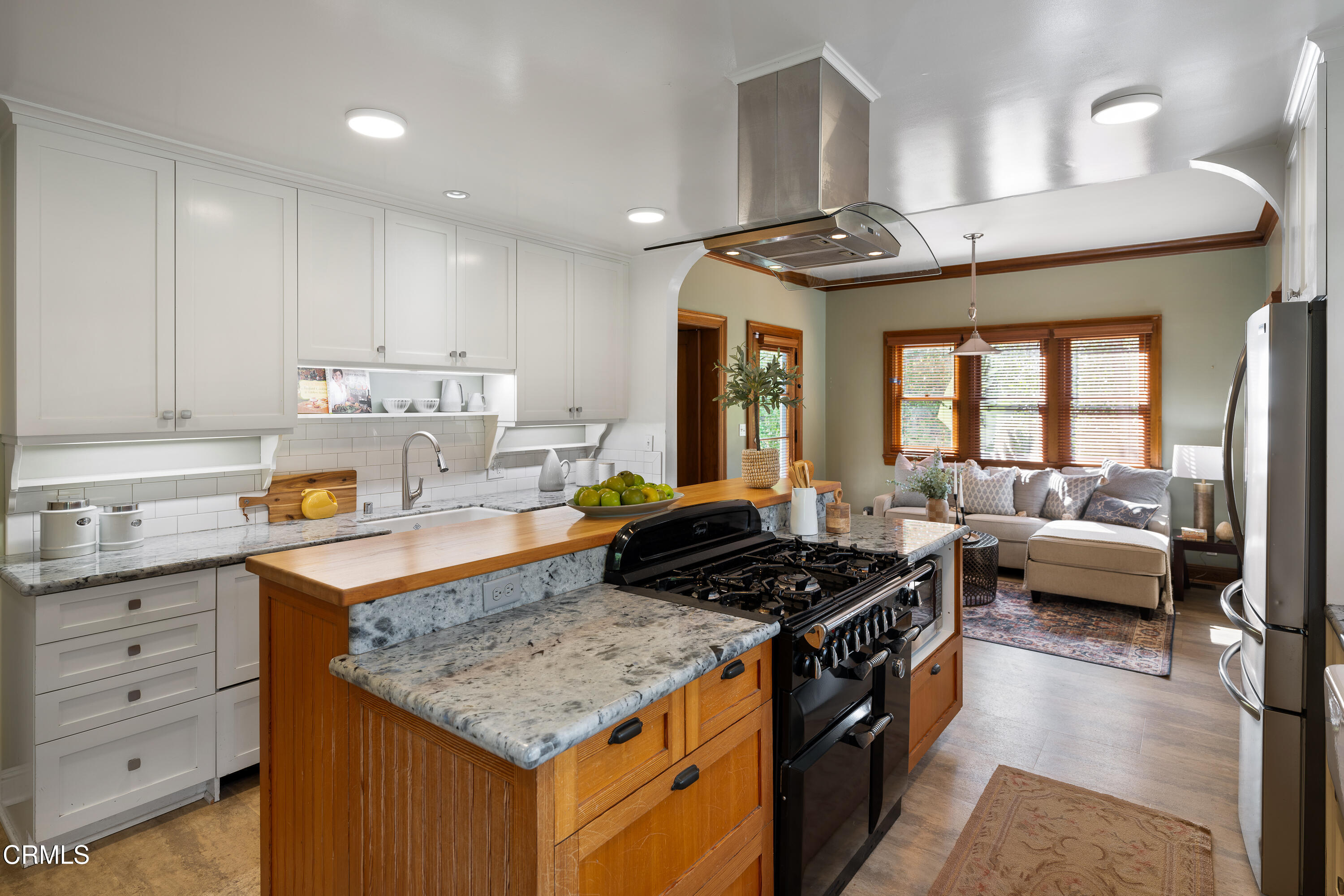 1073 Atchison Street Pasadena, CA 91104 - Photo 22 of 66 a kitchen with granite countertop kitchen island stainless steel appliances a stove a sink and living room view