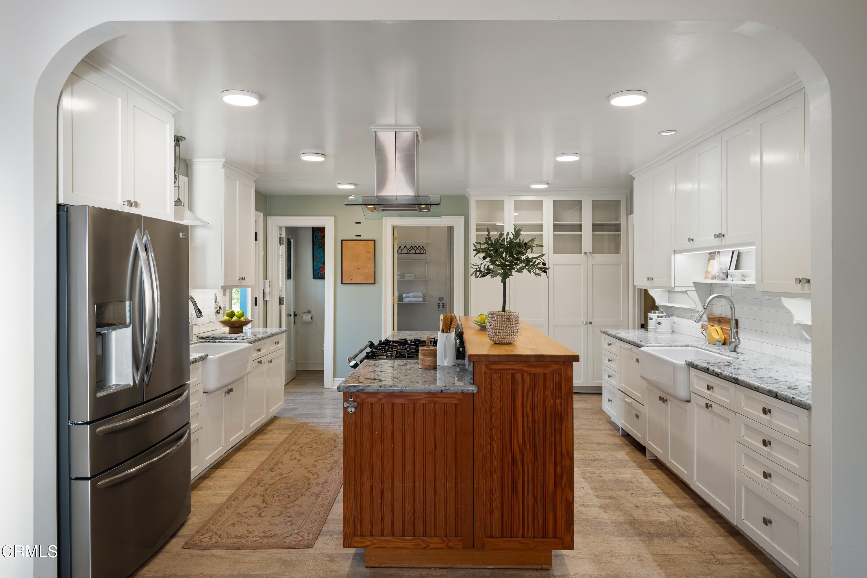 1073 Atchison Street Pasadena, CA 91104 - Photo 23 of 66 a kitchen with stainless steel appliances kitchen island granite countertop a refrigerator and a stove top oven