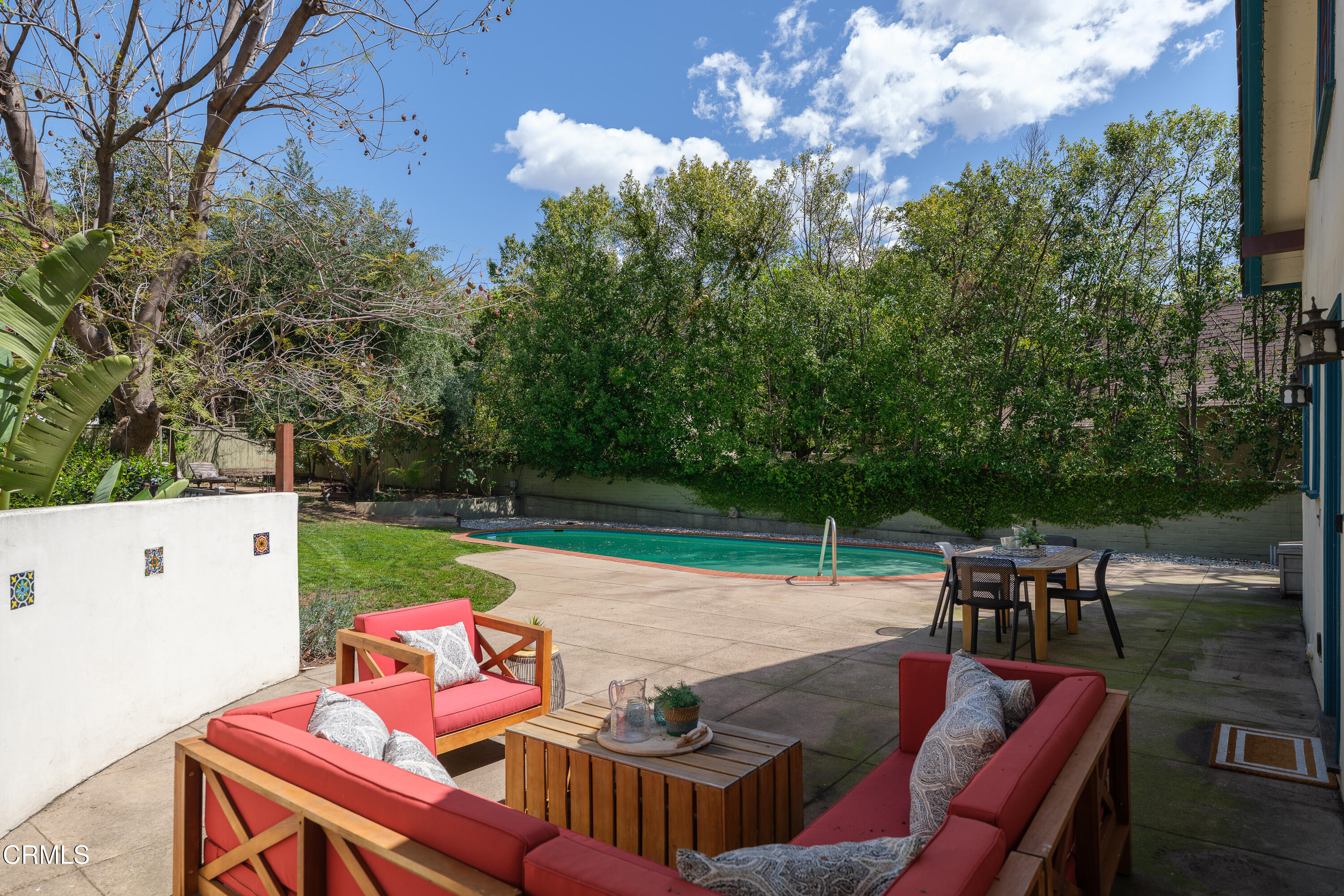 1073 Atchison Street Pasadena, CA 91104 - Photo 49 of 66 a view of a patio with table and chairs potted plants with wooden floor
