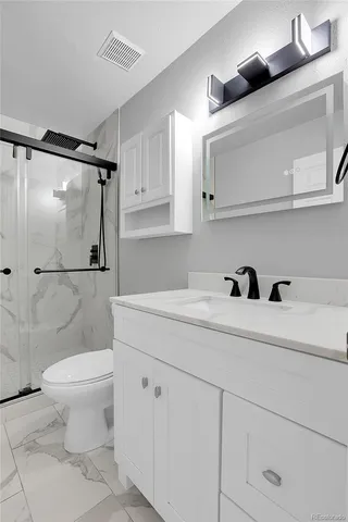 a bathroom with a sink toilet and shower