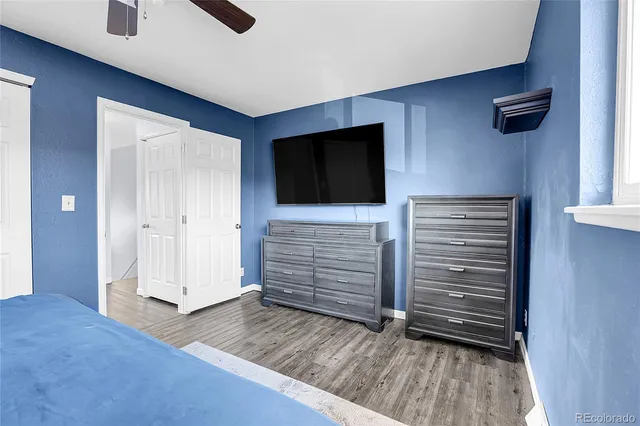 a view of room with wooden floor and flat screen tv