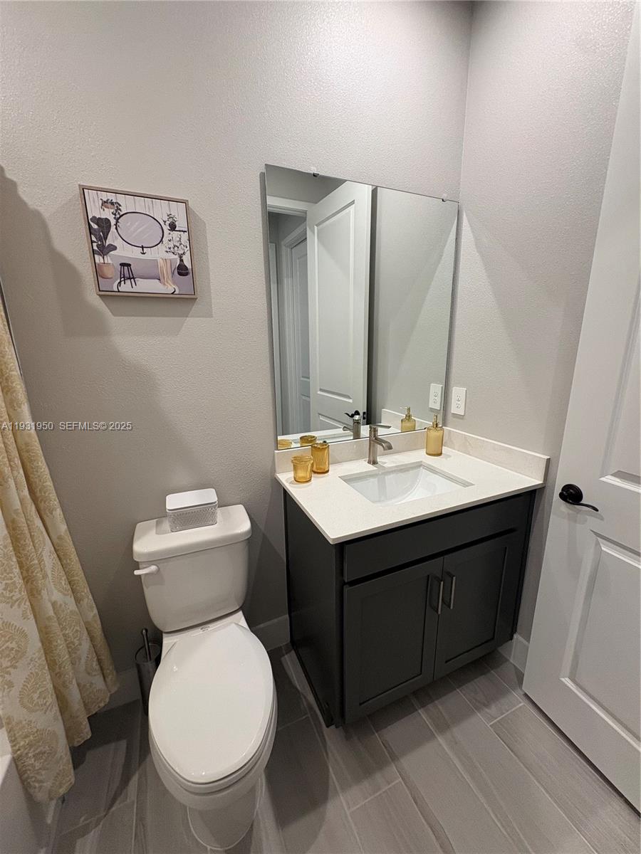 5020 124th Avenue East Parrish, FL 34219 - Photo 12 of 25 a bathroom with a sink and a toilet