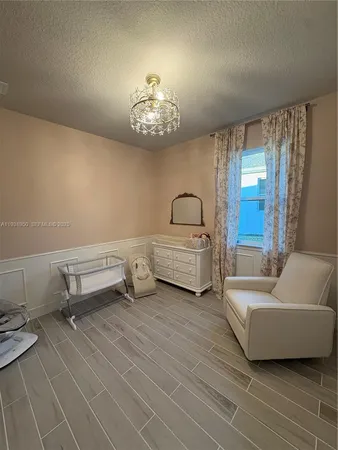 a living room with furniture a flat screen tv and a large window